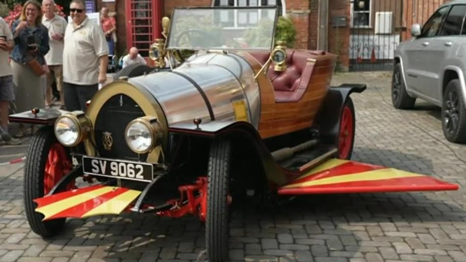 A replica of Chitty Chitty Bang Bang parked in the square outside Ludlow Castle