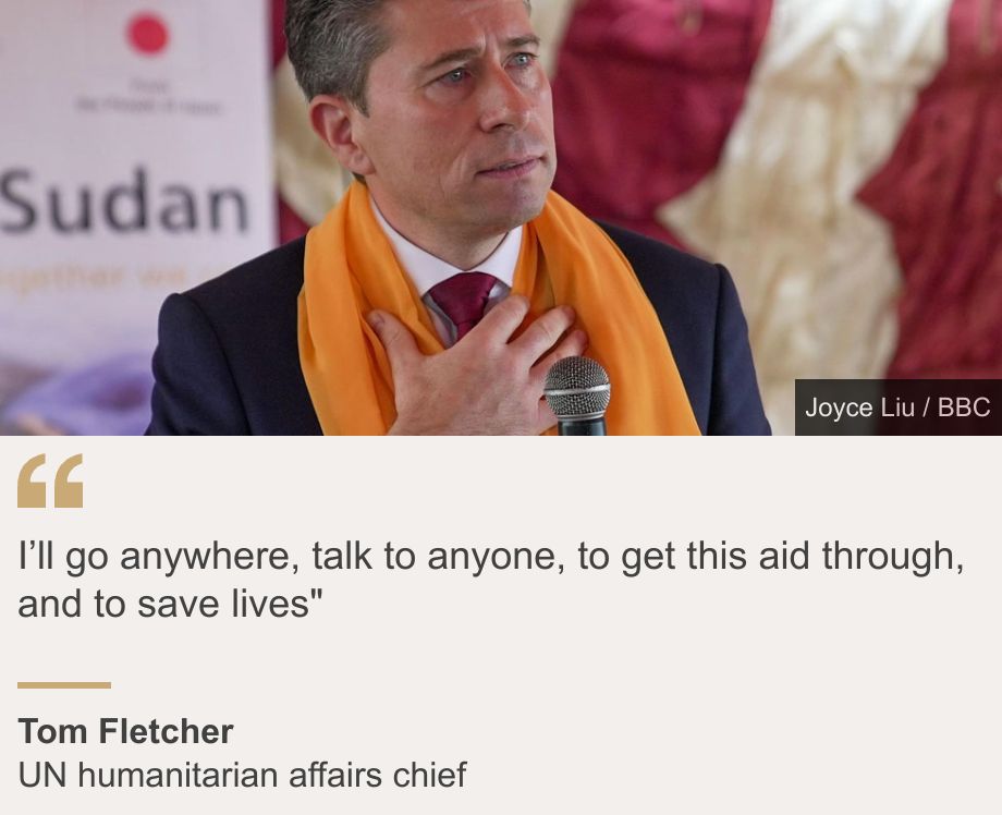 "I’ll go anywhere, talk to anyone, to get this aid through, and to save lives"", Source: Tom Fletcher, Source description: UN humanitarian affairs chief, Image: Tom Fletcher holding a microphone