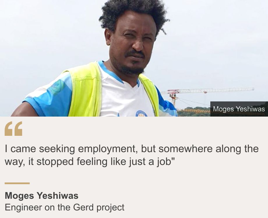 "I came seeking employment, but somewhere along the way, it stopped feeling like just a job"", Source: Moges Yeshiwas, Source description: Engineer on the Gerd project, Image: Moges Yeshiwas squinting into the camera. He is wearing a sports T-shirt and a hi-viz waistcoat. A crane can be seen in the background.