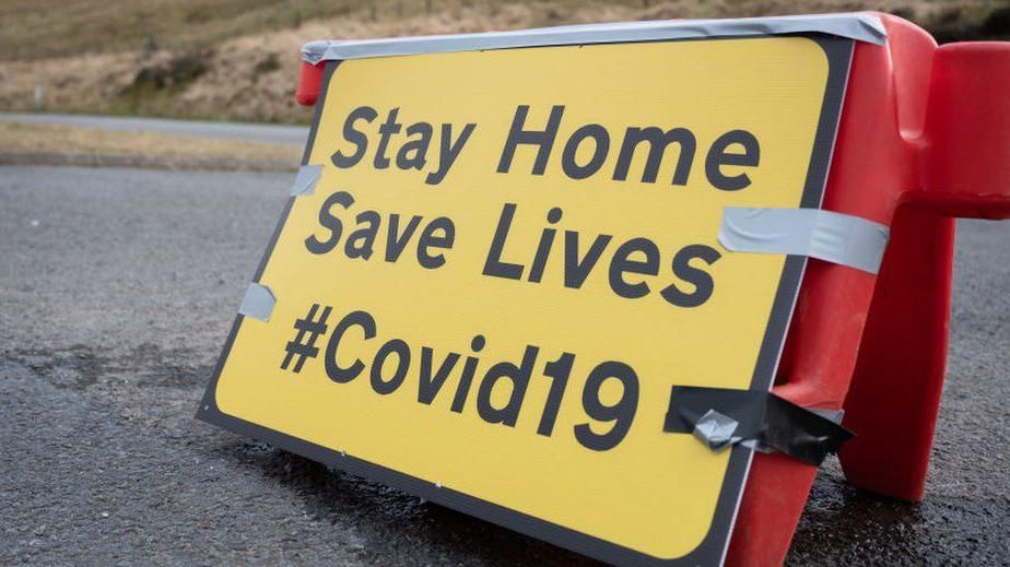 A sign warning the public to stay at home during the Covid pandemic