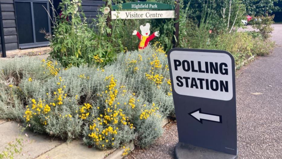 Polling station at Highfield Park, St Albans, with an image of Rupert the Bear in the background