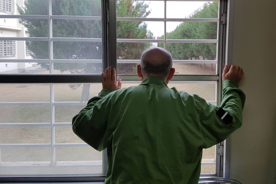 Japanese prisoner looking through bars