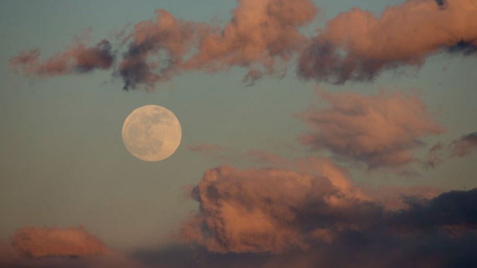 A full moon rises over Rosarito Reservoir on January 20, 2019 near Oropesa, in Toledo province, Spain.