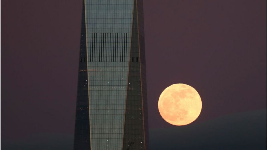 The Super Blood Wolf Moon rises behind One World Trade Center in New York City on January 20, 2019 as seen from Jersey City, New Jersey.