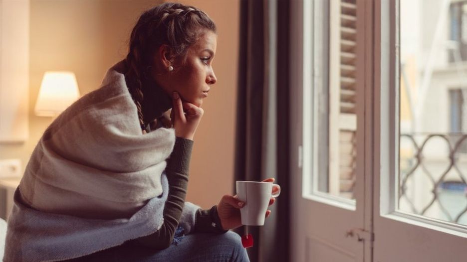 Woman looking out of window