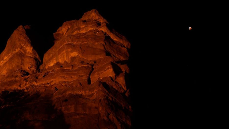 The Super Blood Wolf moon is visible in the sky from Red Rocks Amphitheatre on January 20, 2019 in Golden, Colorado.