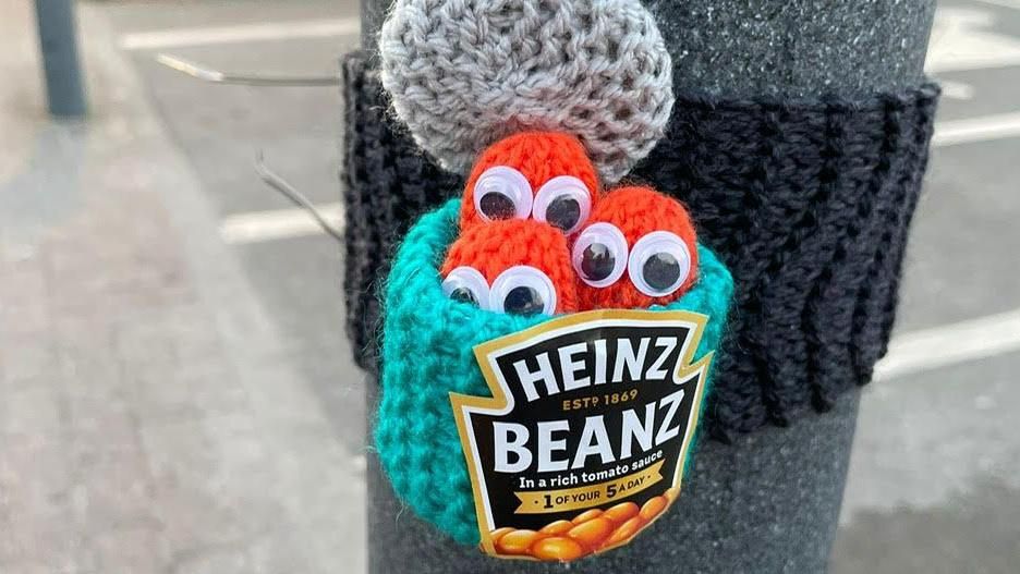 A knitted pot of beans on a post 