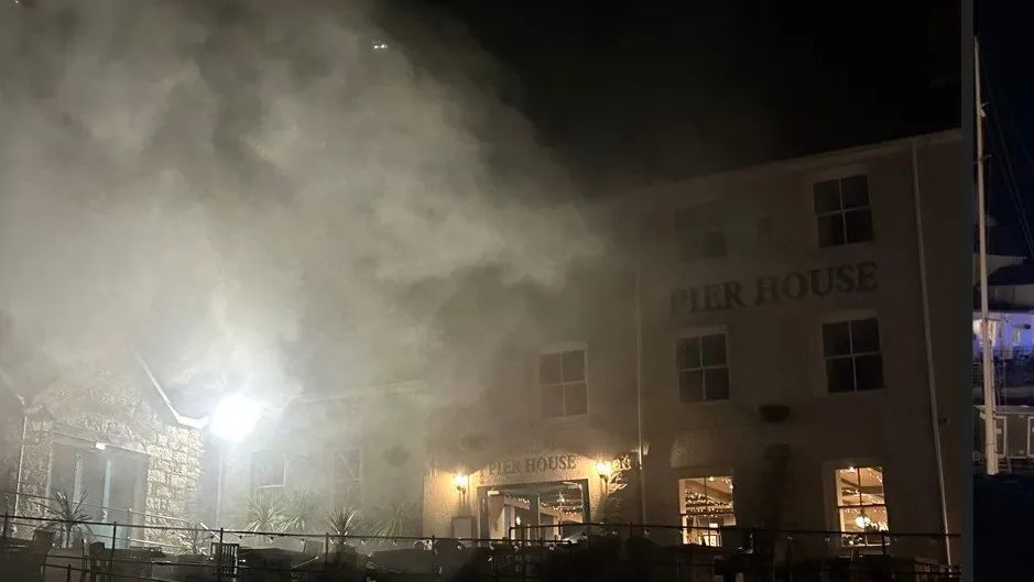 Smoke billowing from the front of the Pier House at night