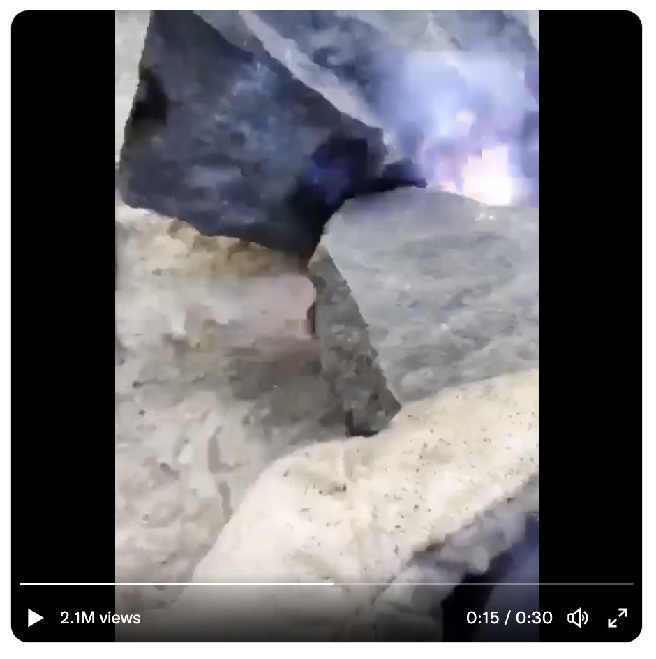 A gloved hand can clearly be seen in this video screenshot claiming to show electrically charged rocks
