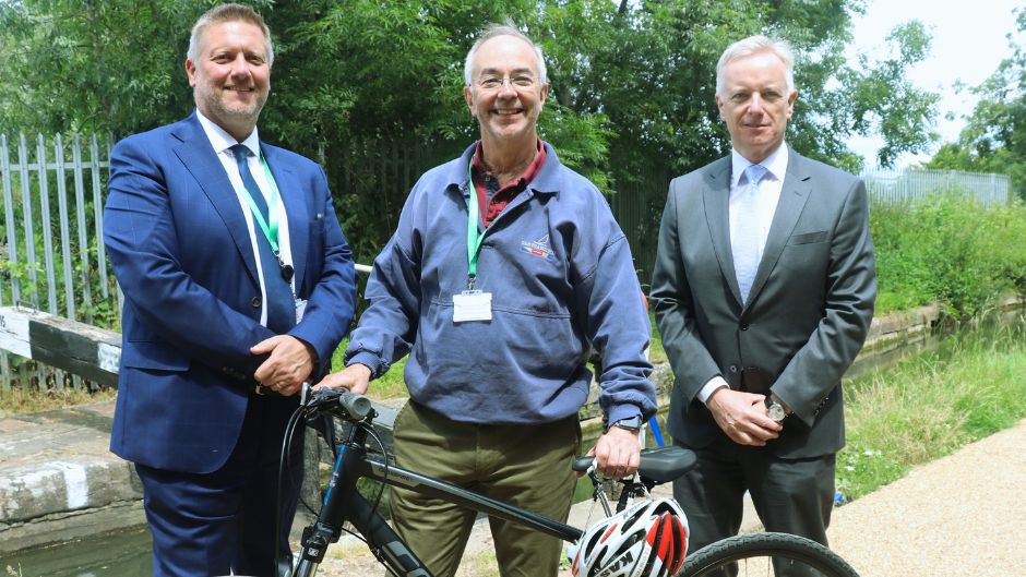 Cabinet member for transport Steven Broadbent, leader of Buckinghamshire Council Martin Tett, and Aylesbury MP Rob Butler, standing on a canal towpath