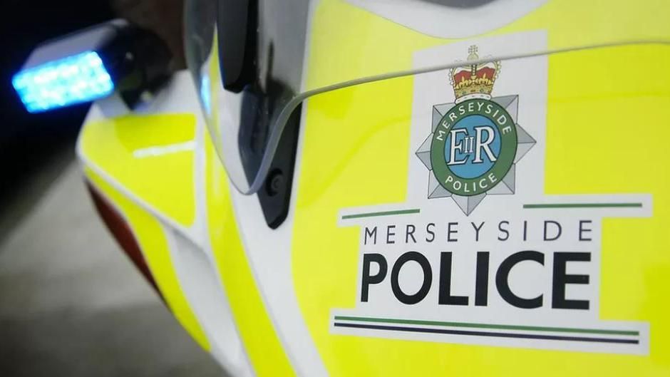 Close up of the Merseyside Police logo on a police vehicle