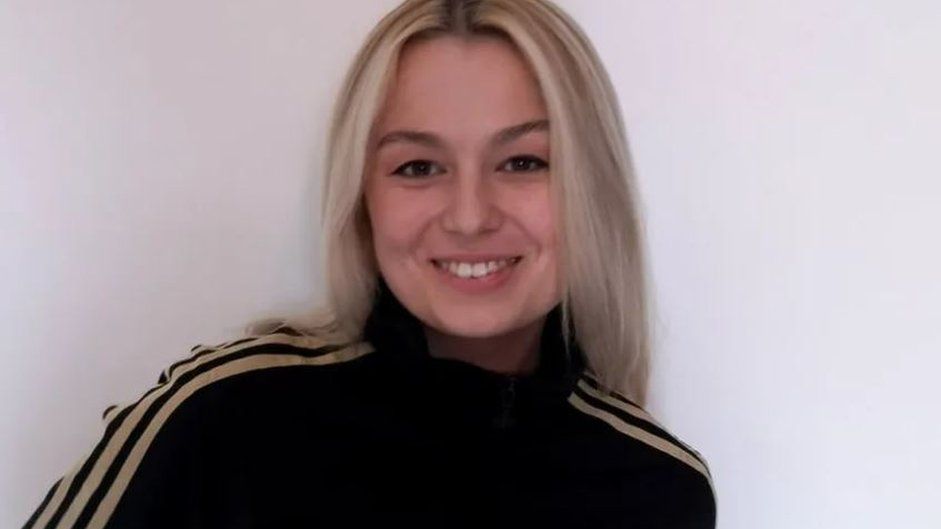 Woman with blonde hair smiles at camera