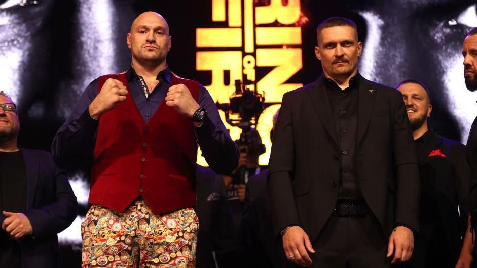 Tyson Fury and Oleksandr Usyk pose for cameras at a news conference