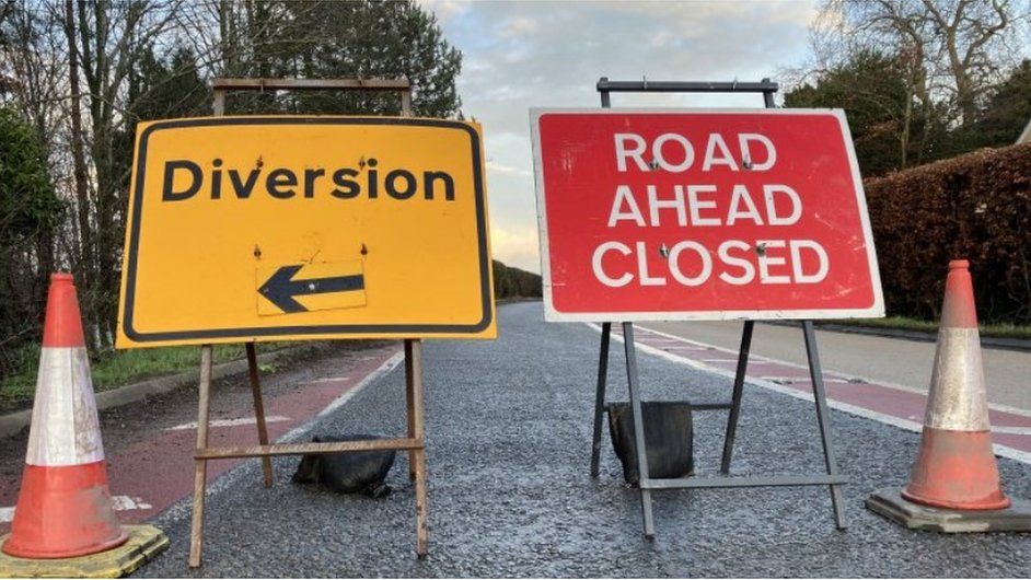A 'road ahead closed' and 'diversion' signs