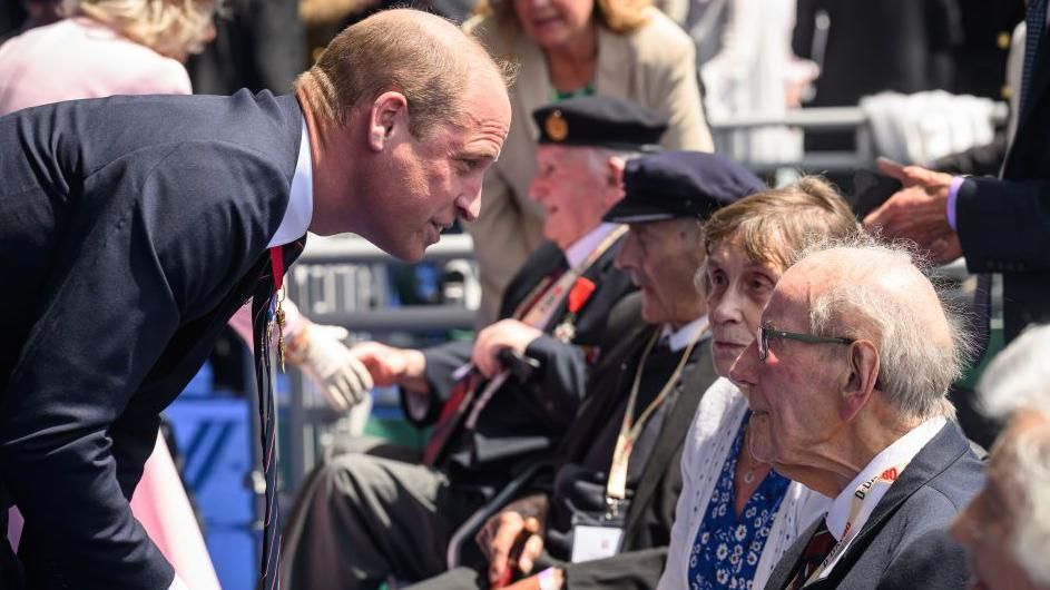 Prince William pauses to speak to a veteran 