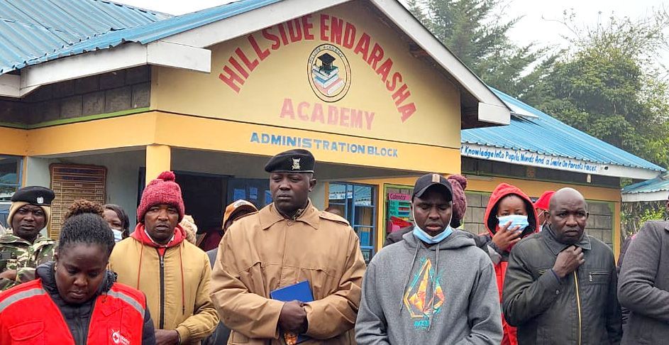 People standing in front of the school building