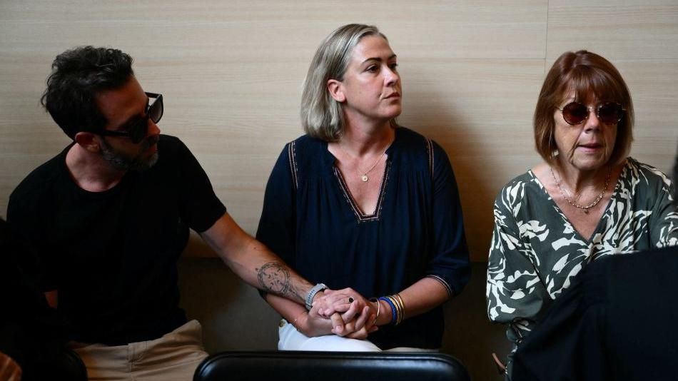 Gisele Pelicot (R) sits beside her daughter Caroline Darian (C) and her son (L) at the courthouse during the trial of her husband accused of drugging her for nearly 10 years and inviting strangers to rape her at their home in Mazan, a small town in the south of France, in Avignon, on September 2, 2024