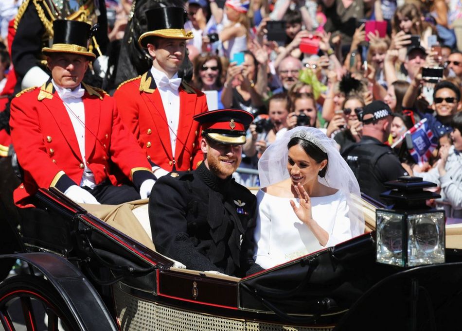 Prince Harry, Duke of Sussex and the Duchess of Sussex in the Ascot Landau carriage during the procession after getting married