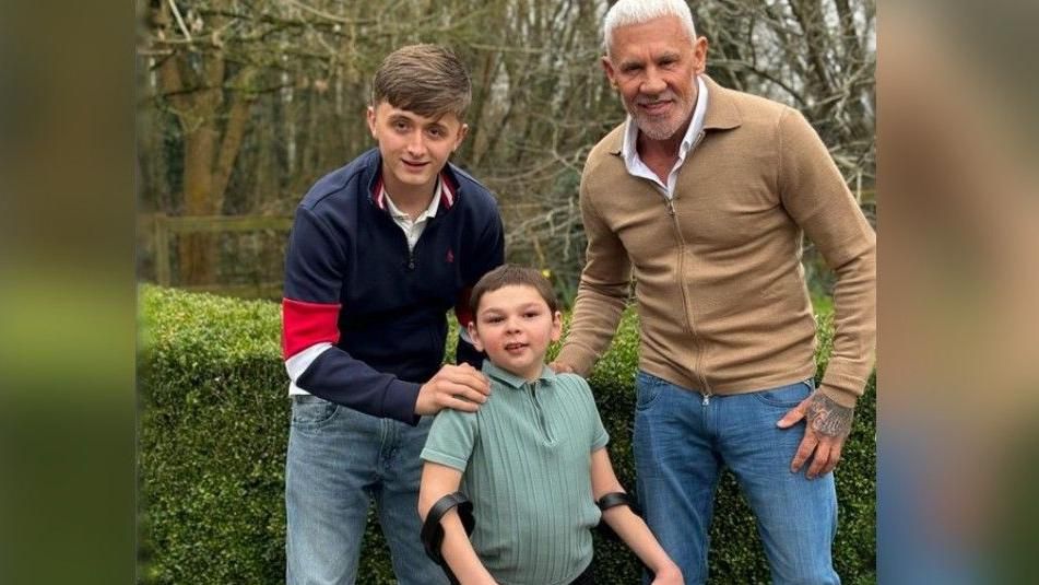 Henry Moores posing for a photograph with Tony Hudgell and Wayne Lineker