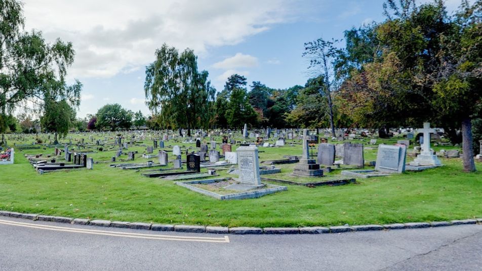 A cemetery with hundreds of gravestones and neat, green grass