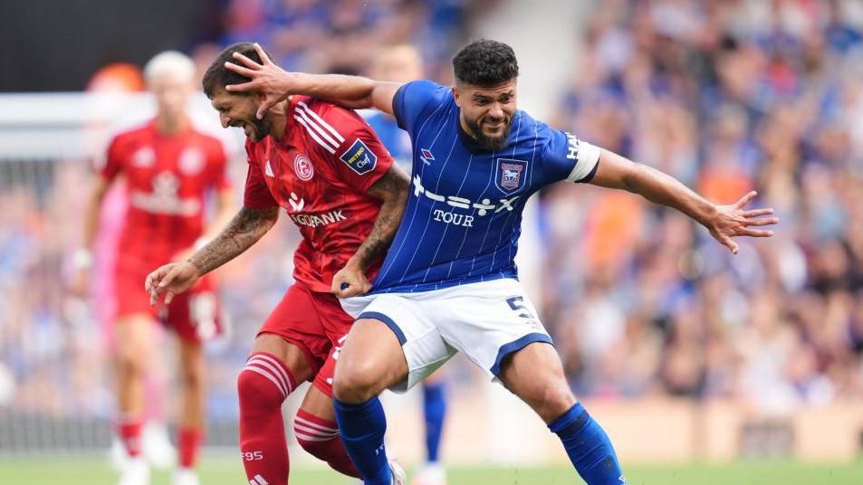 Sam Morsy and Matthias Zimmermann battle for the ball during a match 