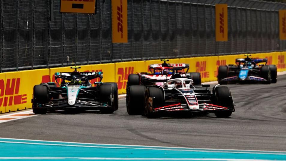 Haas' Kevin Magnussen holds off Mercedes' Lewis Hamilton