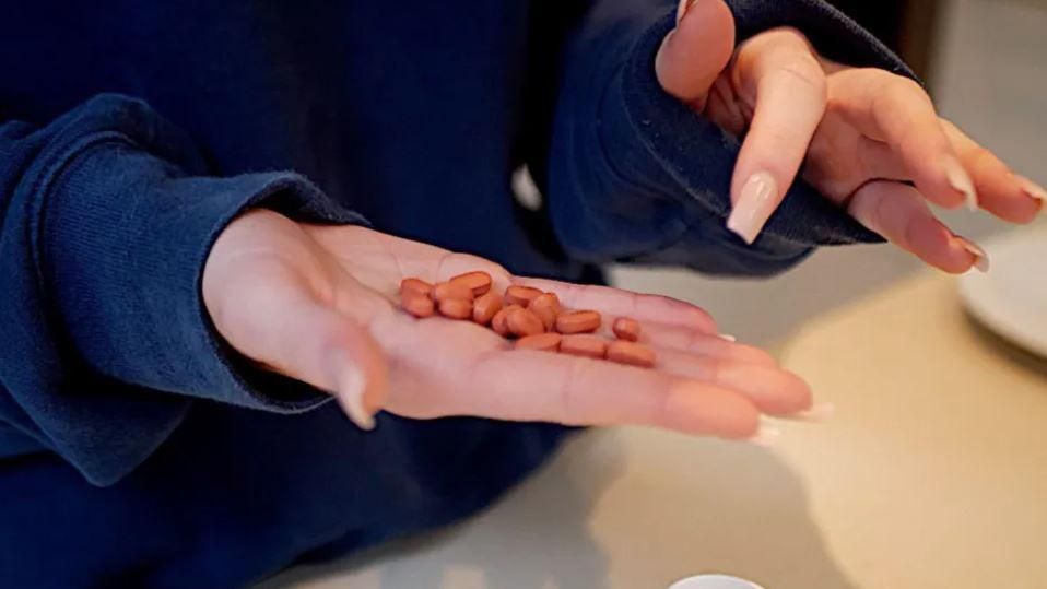 Girl's hand with pills in it