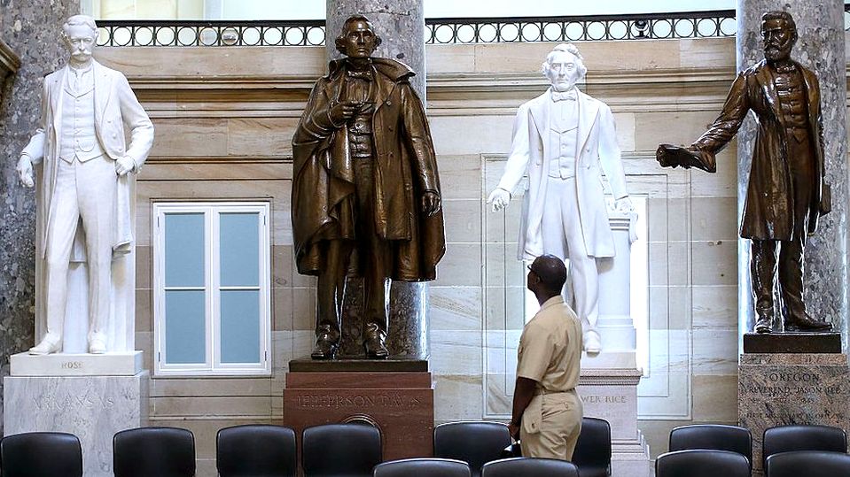 black man looks at confederate soldier