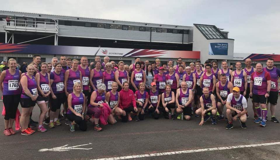 Group photo of Wootton Road Runners members in their pink and purple club colours