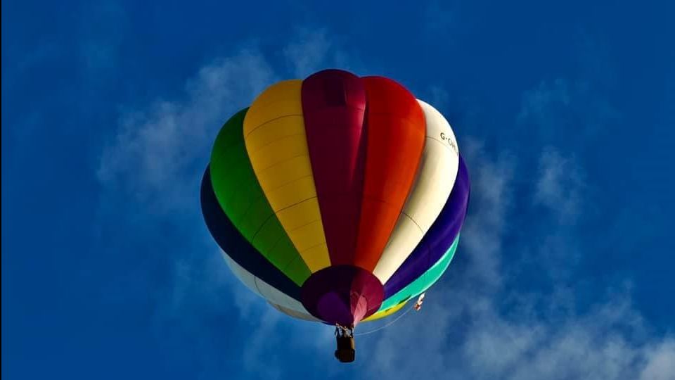 One hot air balloon flying in the sky