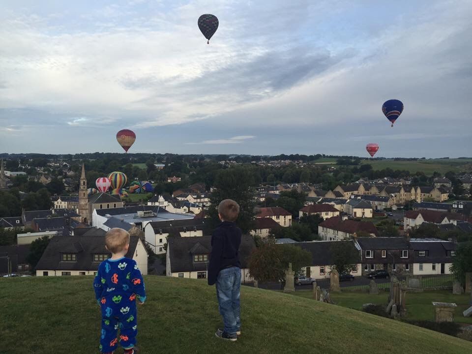 Nathan and Andrew watch hot air balloons in Strathaven
