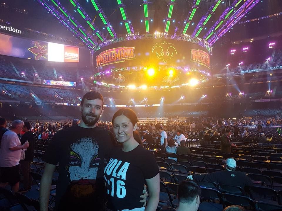 A young couple standing in the crowd at Wrestlemania