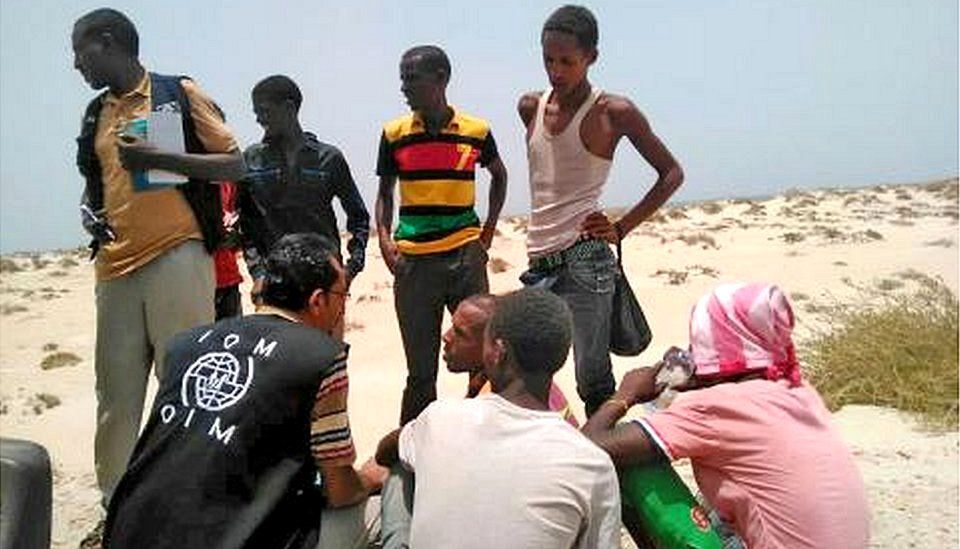 IOM staff members with migrants found on Shabwa beach, Yemen