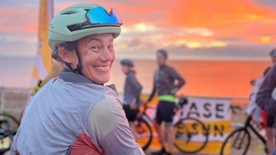 Tracey Moseley on a bike at sunrise
