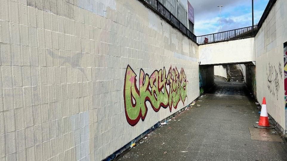 A subway wall with graffiti on it