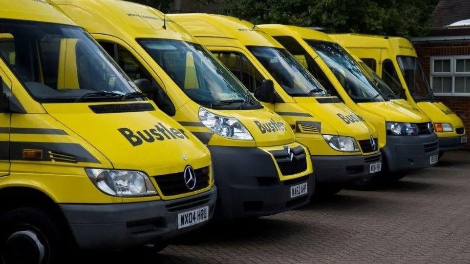 Five yellow Bustler minibuses are parked up