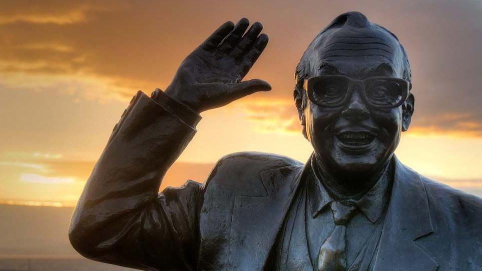 Close up of the Eric Morecambe statue at sunset