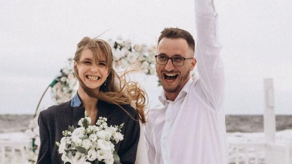 Serhiy and Tania smile to camera at wedding