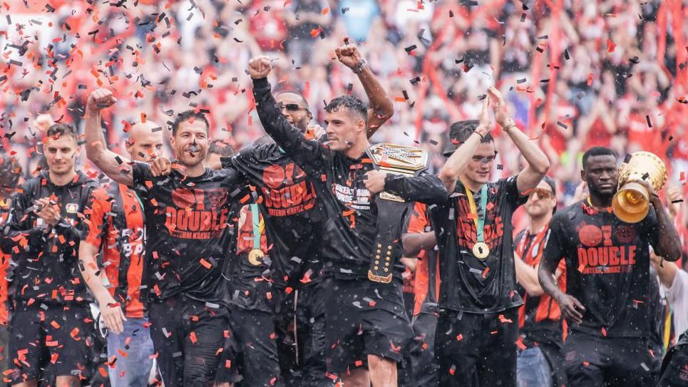 Bayer Leverkusen players observe pinch nan convention and cup trophies astatine nan extremity of past season