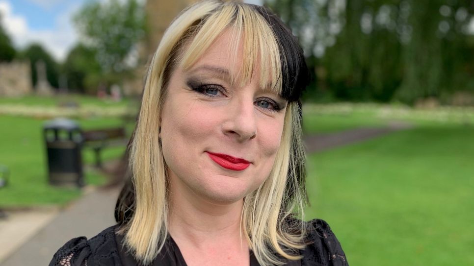 Bernadette Louise in a black top with black and white hair