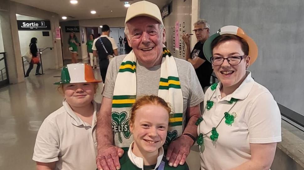 Dearbhaile brady in team Ireland colours with her granda Brian McWilliams  sister Sarah and mum Brigid, in an airport in Paris