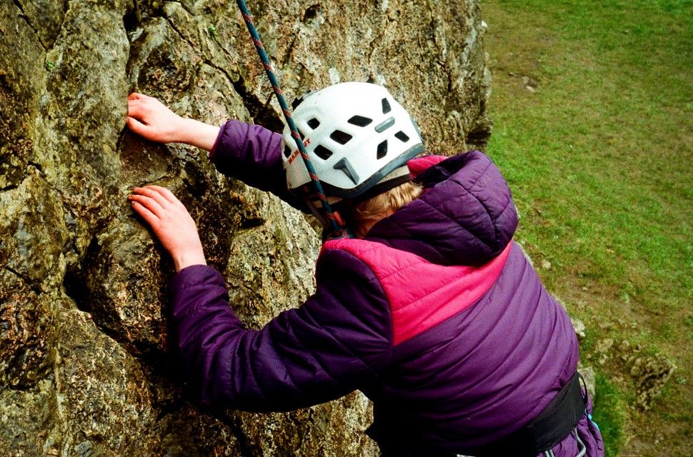 Pip Rowlands climbing rock