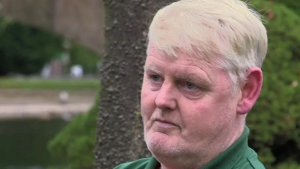 Darron Coster wearing green polo shirt looking at the cameraduring an interview with the BBC