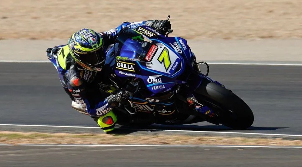Ryan Vickers on a powerful motorbike in racing gear leans into a corner on a racing circuit