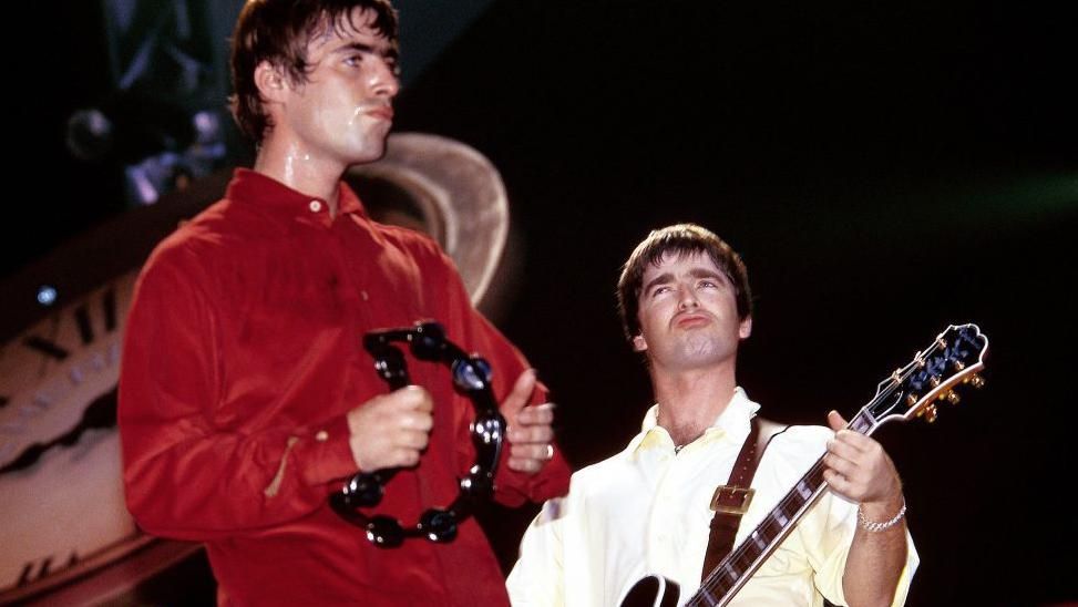 Liam and Noel Gallagher rocking out on stage in the 1990s