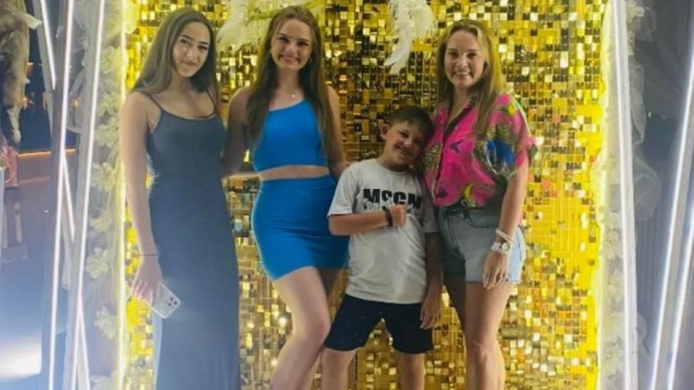 Jodie Tracey (Pictured right) and her three children smiling together on their holiday