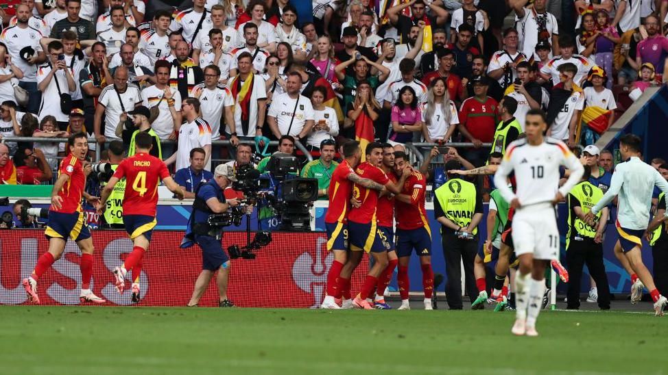 Spain celebrate their extra-time winner against Germany