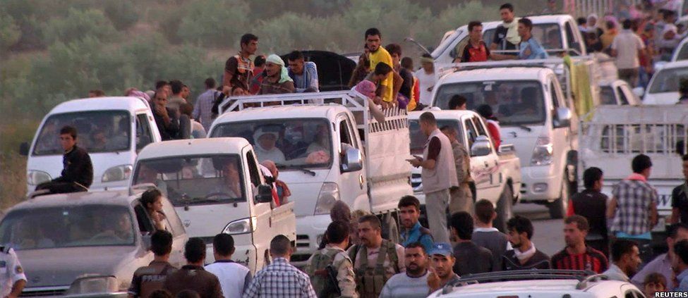 Iraqis people from the Yazidi community arriving in Irbil in northern Iraq after Islamic militants attacked the towns of Sinjar and Zunmar