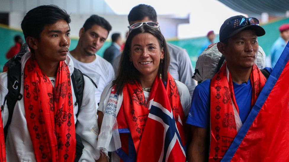 Norwegian climber Kristin Harila(C) and Tenjen Sherpa(L) at the Tribhuvan International Airport in Kathmandu on 5th August, 2023