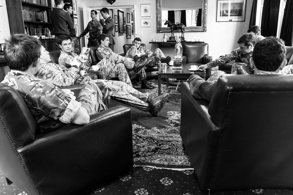 Officers of The Queen's Royal Hussars officers’ mess meet for coffee after lunch at Athlone Barracks. Sennelager, 2018